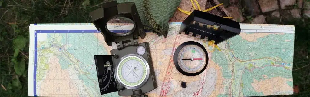 Image featuring a lensatic and a baseplate compass.