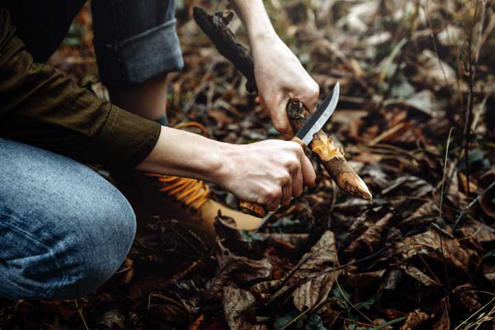 Photo of a man working a piece of wood. 