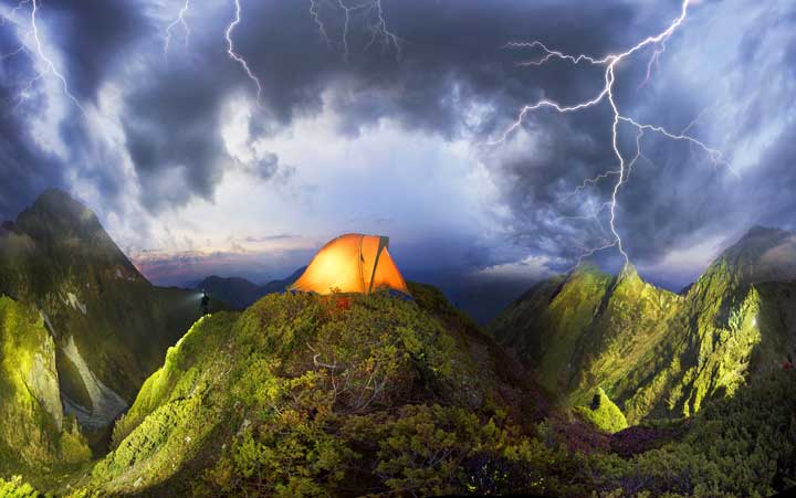 Photo of a tent in the middle of a thunderstorm. 