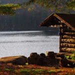 Vibrant fall foliage surrounds this primitive shelter.